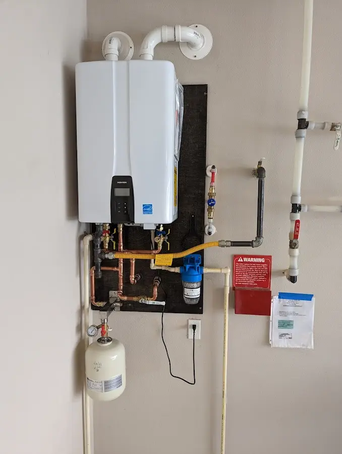 Professional plumber installing copper piping in a Dewey-Humboldt home